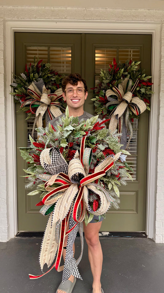 Sage, red, and green faux wreath made by JME paired with a hand tied JME bow with a touch of black and white! Very full About 24 inches wide