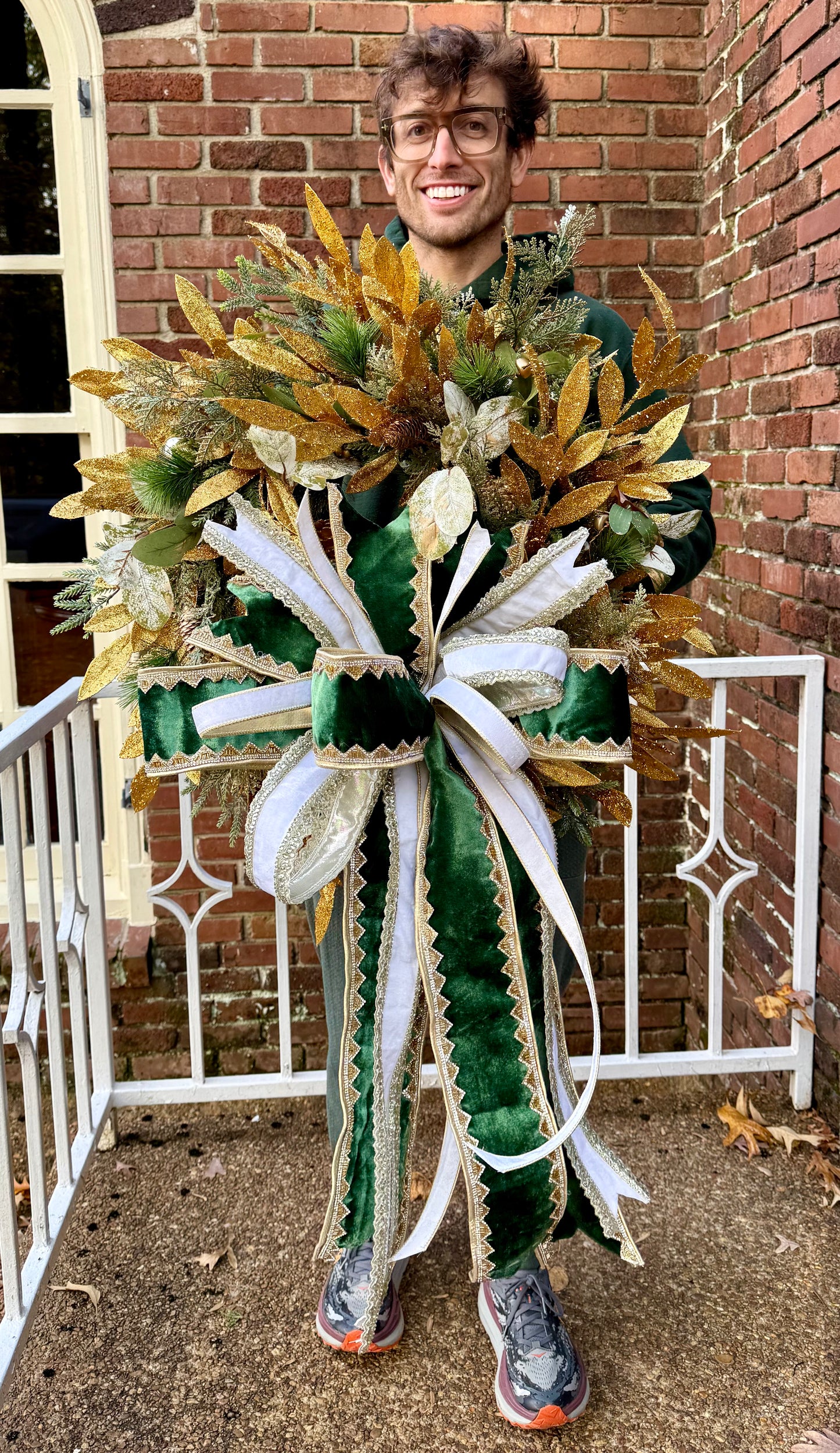 Greens and gold wreath. Handmade wreath by JME paired WITH A JME Handtied bow of velvets and jewels. About 24 inches wide