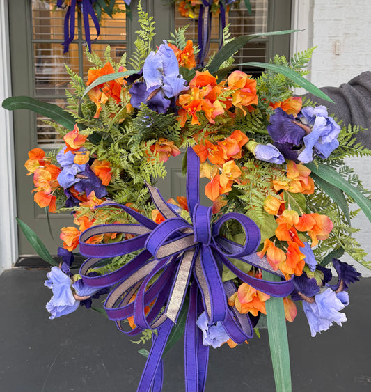 Purple and Orange Iris Wreath with Purple Hand Tied JME Bow. About 24"x 24"