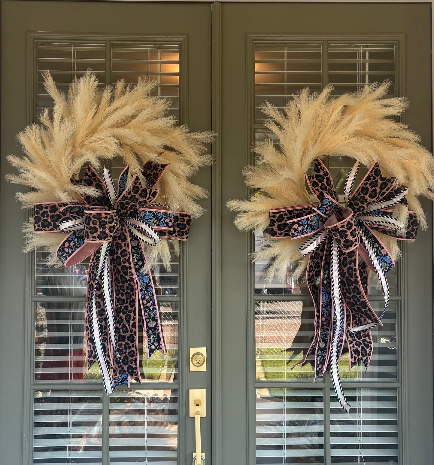 Faux Cream Plume Wreath paired with a JME hand tied bow featuring a pink and black Leopard Chenille and floral ribbon combo. Approximately 26 inches in diameter. Some fluffing may be required upon arrival.