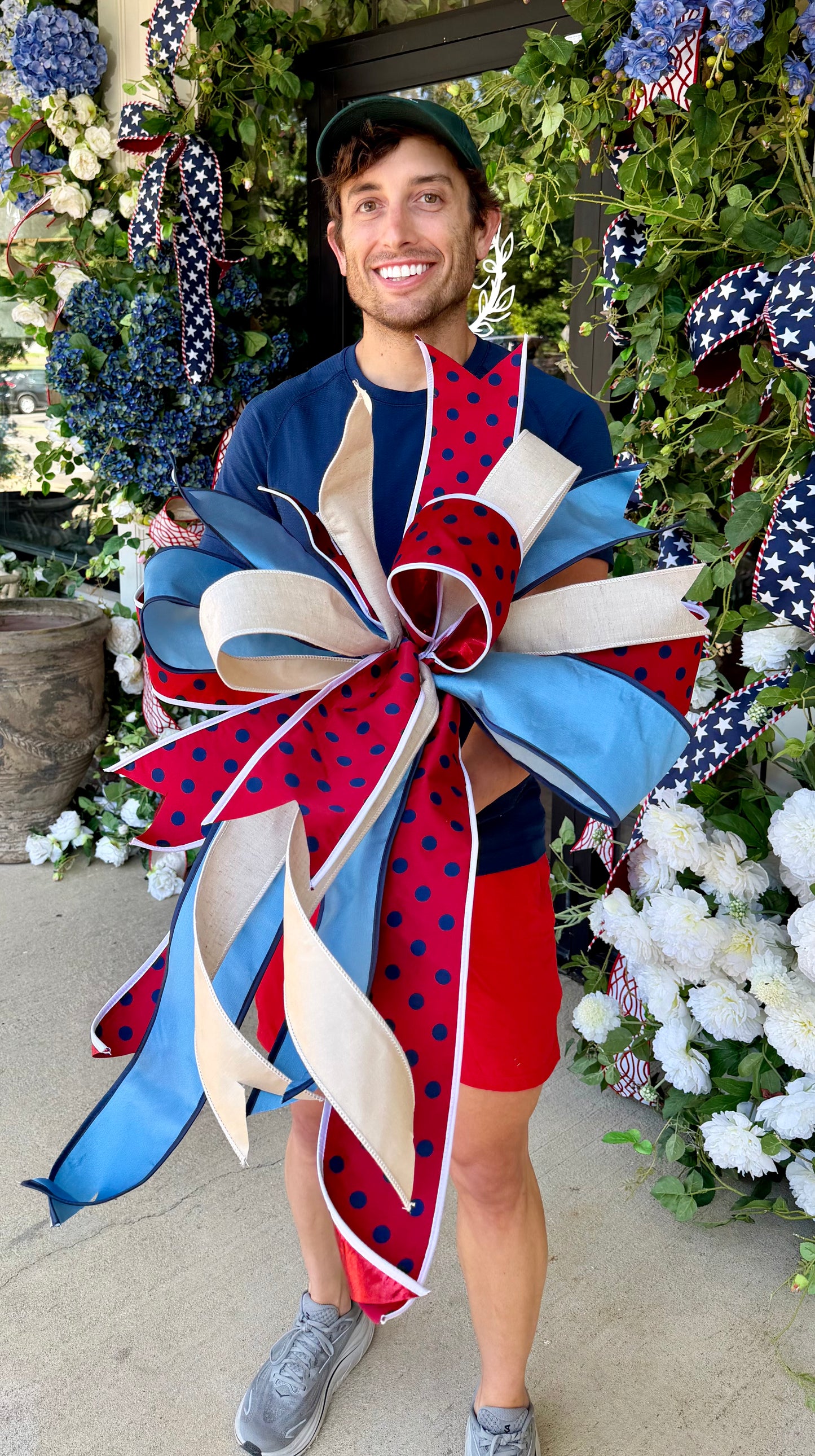 JME RED with navy polka dots bow. Hand-tied by JME. Approximately 23inches wide and inches 32inches long.